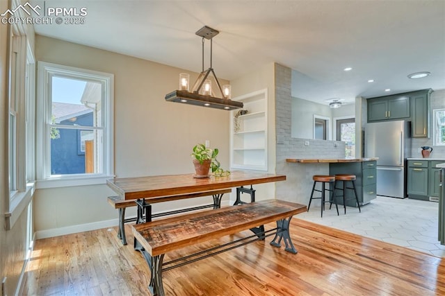 1445 N Foote Ave, Colorado Springs, CO 80909 - dining room with recessed lighting, light wood-style flooring, and a baseboard heating unit