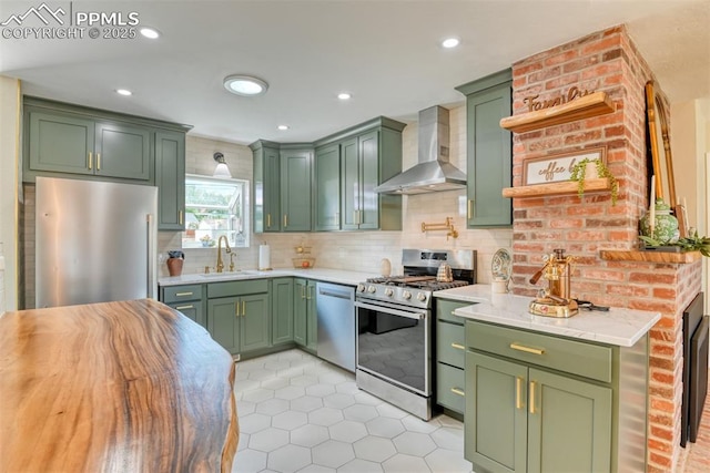 1445 N Foote Ave, Colorado Springs, CO 80909 - kitchen featuring green cabinets, wall chimney exhaust hood, stainless steel appliances, light tile patterned floors, and light countertops