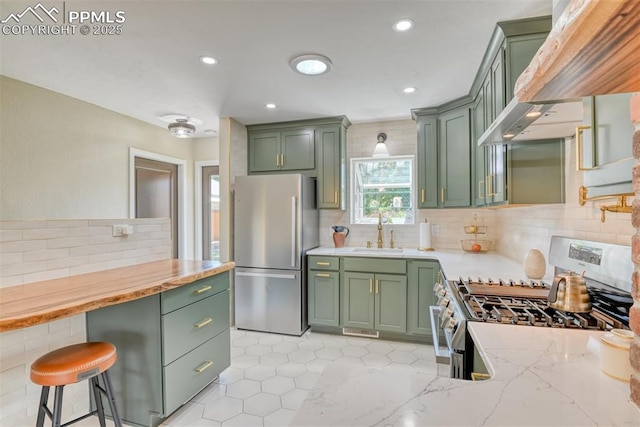 1445 N Foote Ave, Colorado Springs, CO 80909 - kitchen featuring green cabinets, appliances with stainless steel finishes, tasteful backsplash, plenty of natural light, and recessed lighting