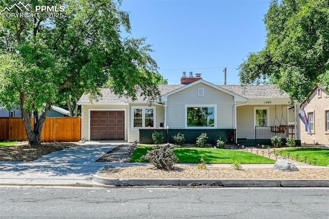1445 N Foote Ave, Colorado Springs, CO 80909 - single story home featuring a garage, concrete driveway, roof with shingles, covered porch, and a chimney
