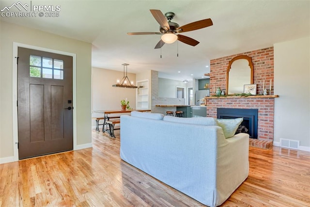 1445 N Foote Ave, Colorado Springs, CO 80909 - living area featuring a fireplace, light wood-type flooring, and a ceiling fan