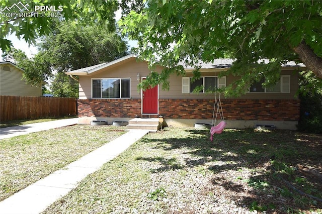 719 Lansing Dr, Colorado Springs, CO 80909 - view of front of house featuring brick siding
