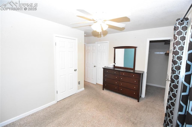 719 Lansing Dr, Colorado Springs, CO 80909 - unfurnished bedroom featuring carpet, ceiling fan, and multiple closets