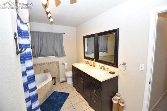 719 Lansing Dr, Colorado Springs, CO 80909 - full bathroom with a garden tub, tile patterned floors, double vanity, and a ceiling fan