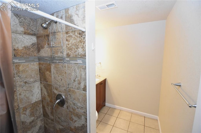 719 Lansing Dr, Colorado Springs, CO 80909 - full bathroom with tile patterned flooring, a tile shower, and vanity