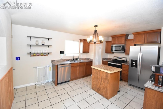 719 Lansing Dr, Colorado Springs, CO 80909 - kitchen with appliances with stainless steel finishes, a center island, a chandelier, and brown cabinets