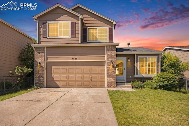 4585 W Jet Wing Cir, Colorado Springs, CO 80916 - traditional-style house with a garage, concrete driveway, and brick siding
