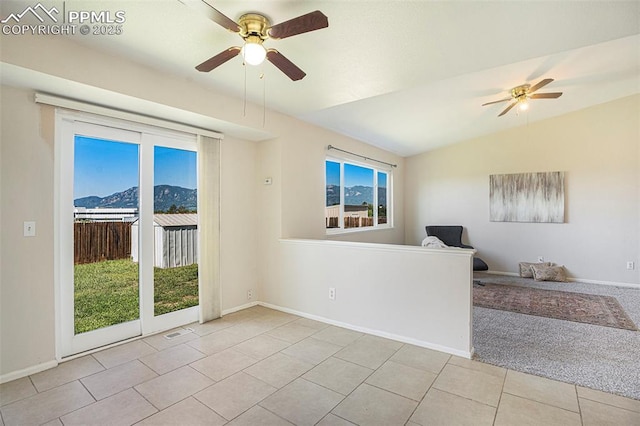 4585 W Jet Wing Cir, Colorado Springs, CO 80916 - spare room with a ceiling fan, tile patterned flooring, a mountain view, and baseboards
