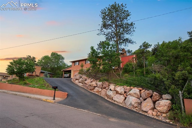 443 E Fountain Pl, Manitou Springs, CO 80829 - obstructed view of property with driveway and an attached garage