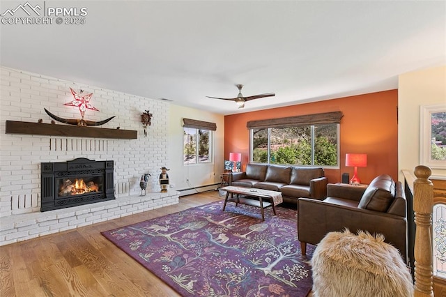 443 E Fountain Pl, Manitou Springs, CO 80829 - living room featuring wood finished floors, ceiling fan, a fireplace, and a baseboard radiator