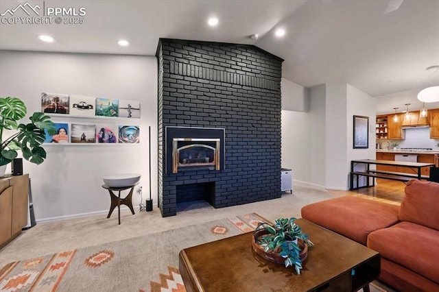 78 Raven Hills Ct, Colorado Springs, CO 80919 - living room featuring a fireplace, vaulted ceiling, light carpet, and recessed lighting