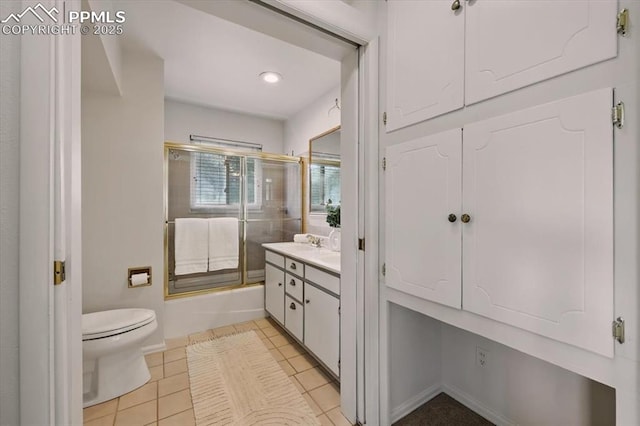 78 Raven Hills Ct, Colorado Springs, CO 80919 - full bathroom with vanity, enclosed tub / shower combo, tile patterned floors, and recessed lighting