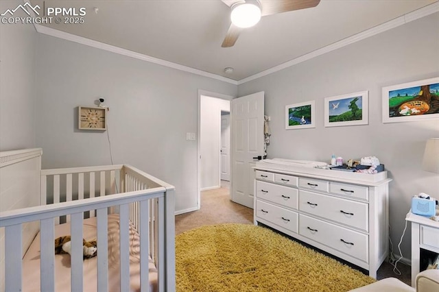 78 Raven Hills Ct, Colorado Springs, CO 80919 - bedroom with a crib, light colored carpet, ornamental molding, and a ceiling fan