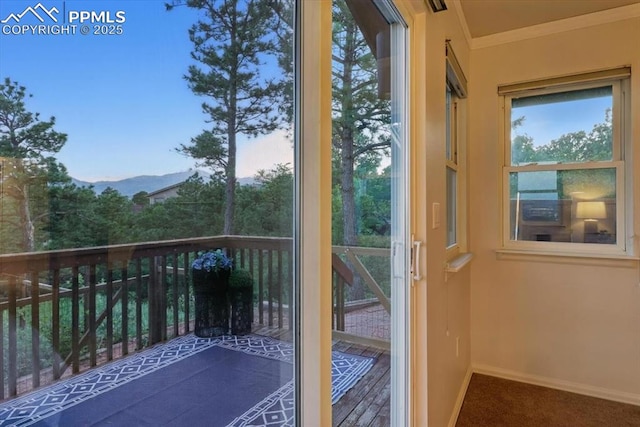 78 Raven Hills Ct, Colorado Springs, CO 80919 - entryway with ornamental molding, a mountain view, and carpet flooring