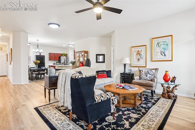 7845 Morning Dew Rd, Colorado Springs, CO 80908 - living area featuring light wood-style floors, a ceiling fan, and a chandelier