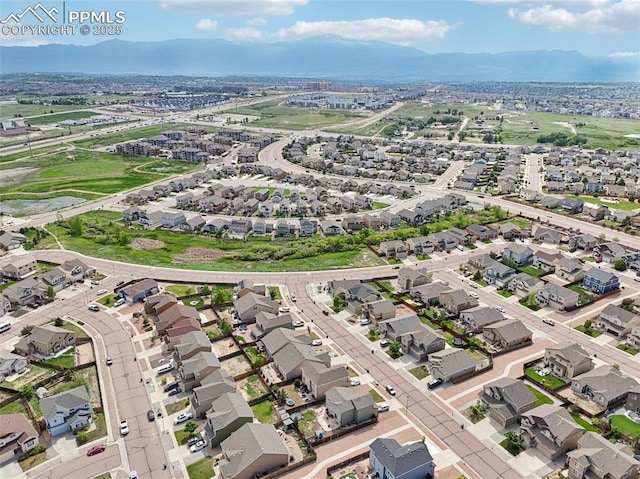 7845 Morning Dew Rd, Colorado Springs, CO 80908 - aerial overview of property's location with a mountain backdrop and nearby suburban area