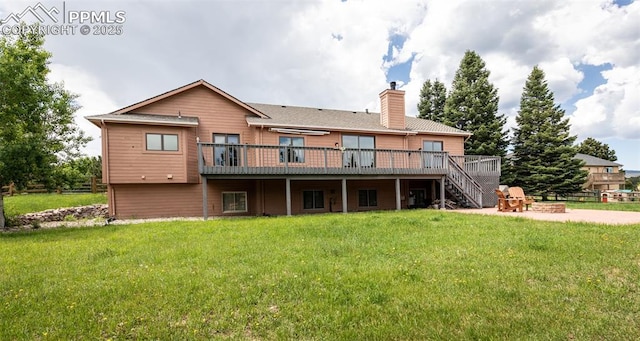1660 Old Antlers Way, Monument, CO 80132 - rear view of property featuring an outdoor fire pit, stairs, a wooden deck, a chimney, and a lawn