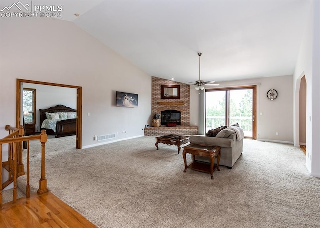 1660 Old Antlers Way, Monument, CO 80132 - living area featuring a fireplace, ceiling fan, vaulted ceiling, and light carpet