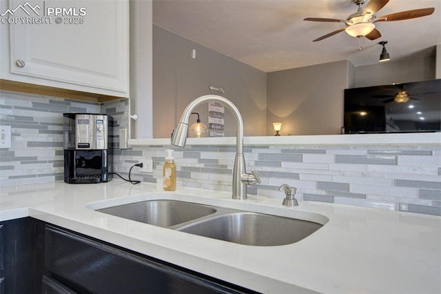 6055 Fescue Dr, Colorado Springs, CO 80923 - kitchen featuring decorative backsplash, white cabinets, and light countertops