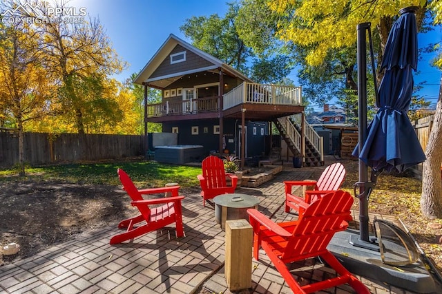1607 W Pikes Peak Ave, Colorado Springs, CO 80904 - rear view of property with a hot tub, an outdoor fire pit, a deck, a patio area, and stairs