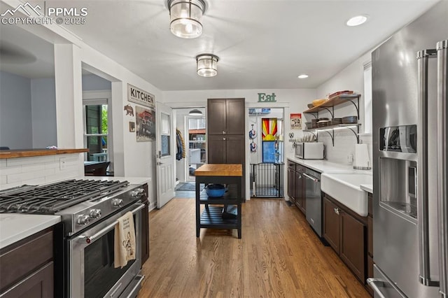 1607 W Pikes Peak Ave, Colorado Springs, CO 80904 - kitchen featuring appliances with stainless steel finishes, light countertops, dark brown cabinets, and recessed lighting