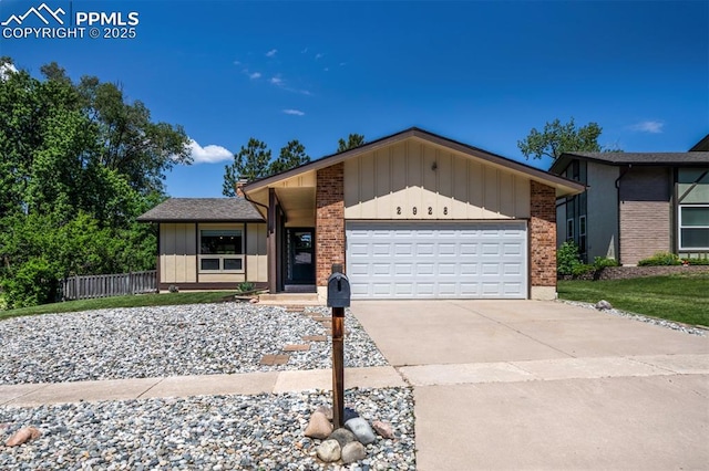 2928 Nevermind Ln, Colorado Springs, CO 80917 - single story home with board and batten siding, an attached garage, concrete driveway, and brick siding