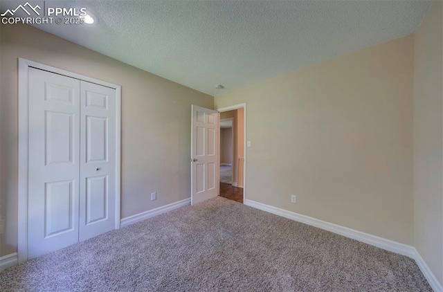 2928 Nevermind Ln, Colorado Springs, CO 80917 - unfurnished bedroom with carpet floors, a textured ceiling, and a closet