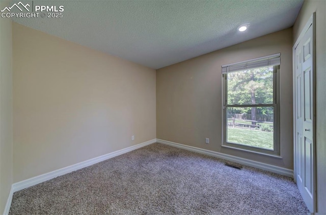 2928 Nevermind Ln, Colorado Springs, CO 80917 - empty room featuring carpet, a textured ceiling, and recessed lighting