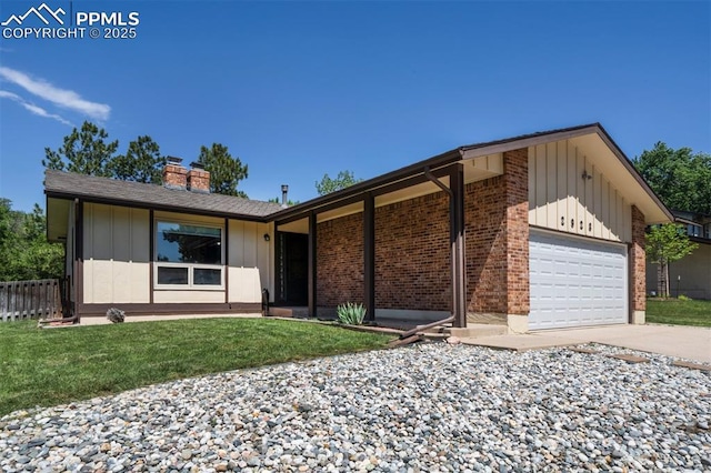 2928 Nevermind Ln, Colorado Springs, CO 80917 - view of front of home featuring board and batten siding, a chimney, an attached garage, concrete driveway, and brick siding