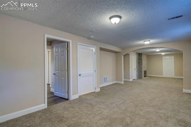2928 Nevermind Ln, Colorado Springs, CO 80917 - carpeted empty room with arched walkways and a textured ceiling