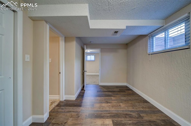 2928 Nevermind Ln, Colorado Springs, CO 80917 - basement featuring a textured ceiling, wood finished floors, and a textured wall
