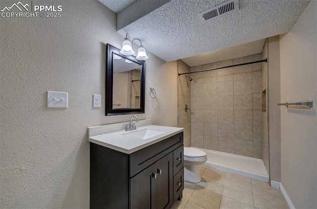 2928 Nevermind Ln, Colorado Springs, CO 80917 - full bathroom featuring tile patterned flooring, vanity, a tile shower, a textured ceiling, and a textured wall
