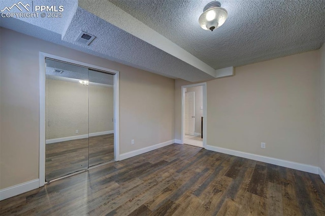 2928 Nevermind Ln, Colorado Springs, CO 80917 - unfurnished bedroom featuring wood finished floors, a textured ceiling, and a closet