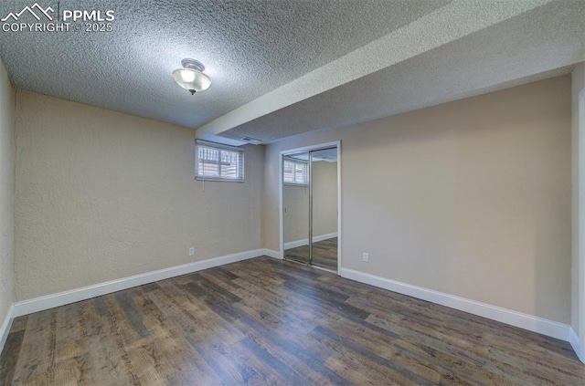 2928 Nevermind Ln, Colorado Springs, CO 80917 - below grade area with a textured ceiling and wood finished floors
