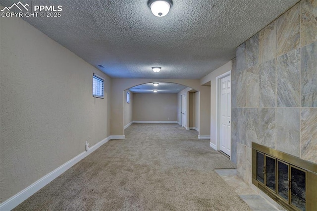 2928 Nevermind Ln, Colorado Springs, CO 80917 - corridor with arched walkways, a textured ceiling, and carpet flooring