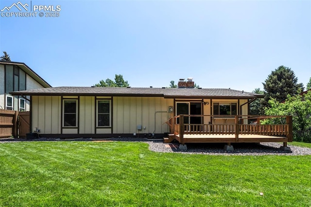 2928 Nevermind Ln, Colorado Springs, CO 80917 - back of house with a deck, a chimney, and board and batten siding