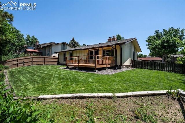 2928 Nevermind Ln, Colorado Springs, CO 80917 - back of house featuring a fenced backyard, a wooden deck, and a chimney