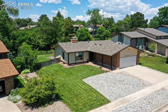 2928 Nevermind Ln, Colorado Springs, CO 80917 - view of front of home with an attached garage, brick siding, concrete driveway, and roof with shingles
