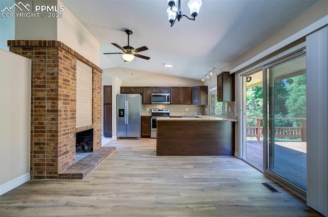 2928 Nevermind Ln, Colorado Springs, CO 80917 - kitchen with appliances with stainless steel finishes, dark brown cabinets, a ceiling fan, light wood finished floors, and lofted ceiling