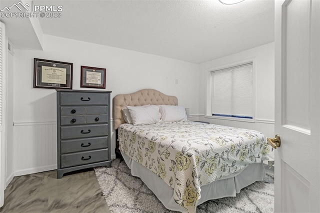 55 Woodbridge Dr, Colorado Springs, CO 80906 - bedroom featuring wainscoting
