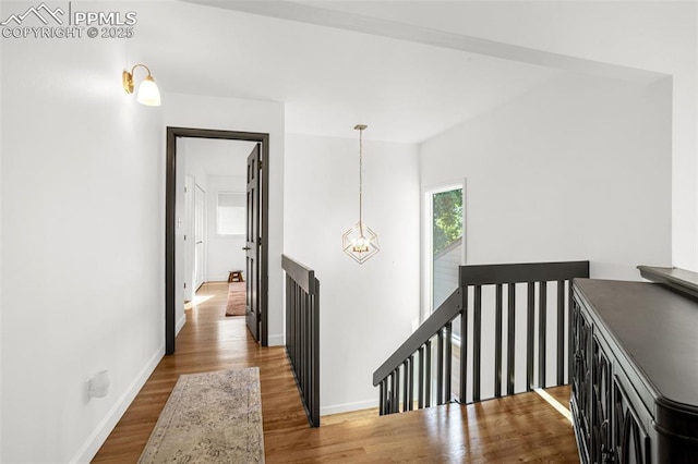 55 Woodbridge Dr, Colorado Springs, CO 80906 - hall with an upstairs landing, a chandelier, and wood finished floors