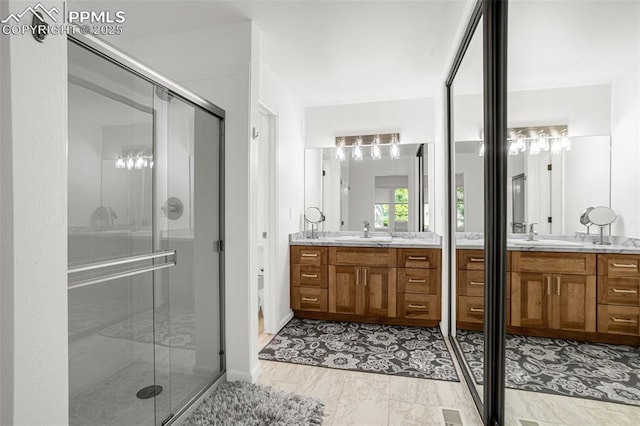 55 Woodbridge Dr, Colorado Springs, CO 80906 - full bathroom with a shower stall and two vanities