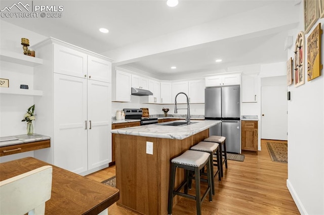 55 Woodbridge Dr, Colorado Springs, CO 80906 - kitchen with appliances with stainless steel finishes, under cabinet range hood, light wood-style flooring, white cabinets, and open shelves