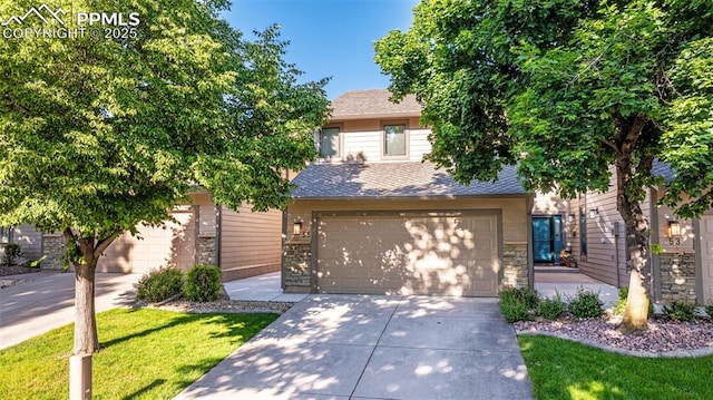 55 Woodbridge Dr, Colorado Springs, CO 80906 - view of property hidden behind natural elements with concrete driveway, a shingled roof, a front yard, stone siding, and an attached garage
