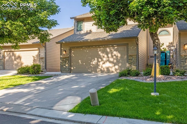 55 Woodbridge Dr, Colorado Springs, CO 80906 - view of front of house with stone siding, driveway, a front yard, a garage, and roof with shingles