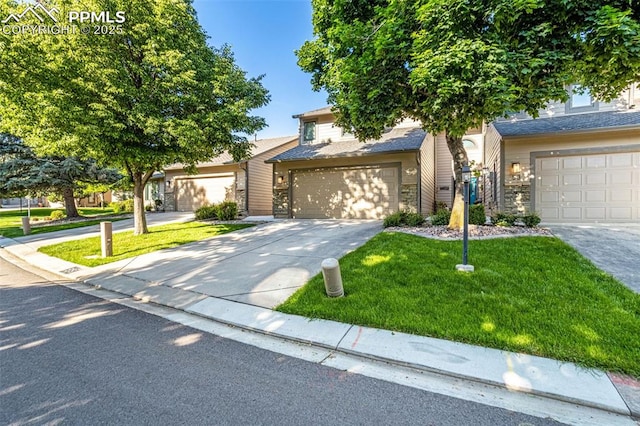 55 Woodbridge Dr, Colorado Springs, CO 80906 - view of property hidden behind natural elements featuring concrete driveway, a garage, a front yard, and stone siding