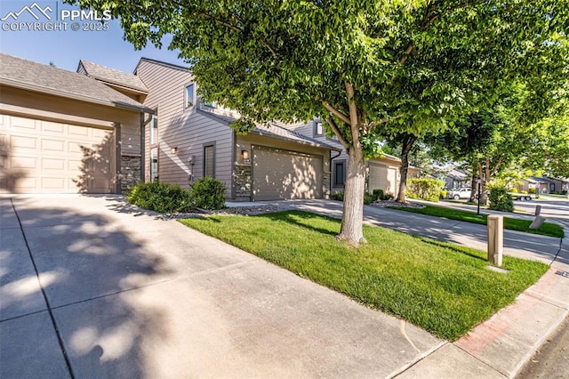 55 Woodbridge Dr, Colorado Springs, CO 80906 - view of front of home with driveway, a front lawn, and an attached garage