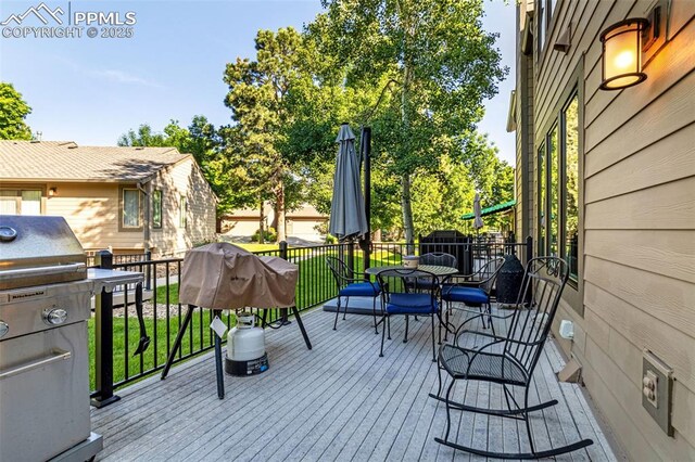 55 Woodbridge Dr, Colorado Springs, CO 80906 - wooden deck with outdoor dining space and grilling area