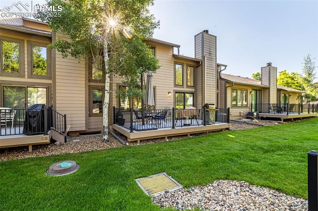 55 Woodbridge Dr, Colorado Springs, CO 80906 - back of property featuring a deck and a lawn