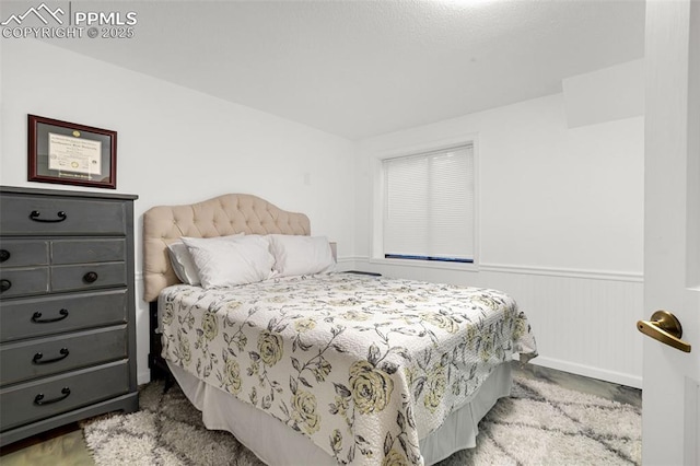 55 Woodbridge Dr, Colorado Springs, CO 80906 - bedroom with a wainscoted wall and carpet